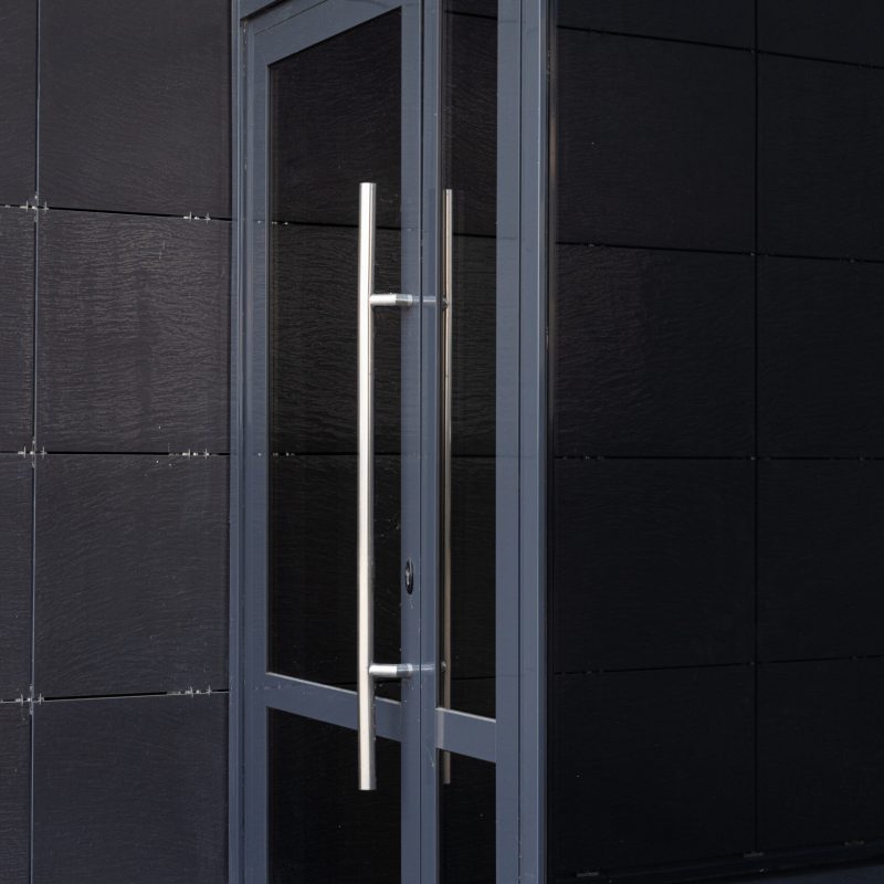 Side-view of glass door - entry to modern office building